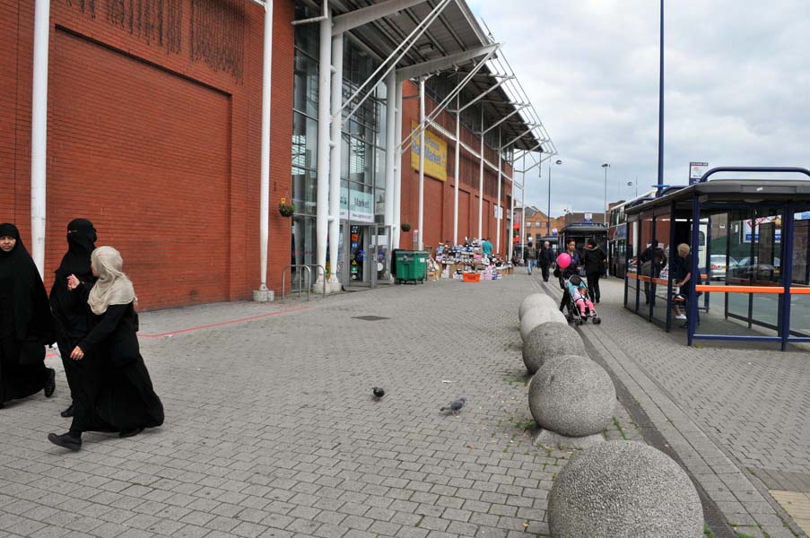 Pedestrians by the Bull Ring.