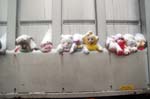 Soft toys on a dust cart.