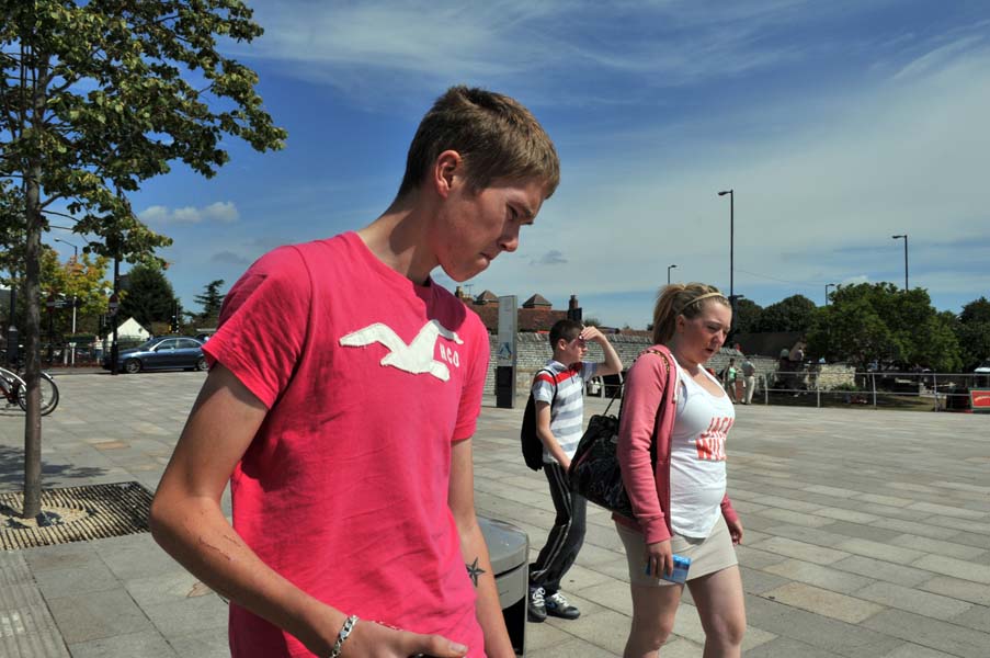 Boy in a pink t shirt.