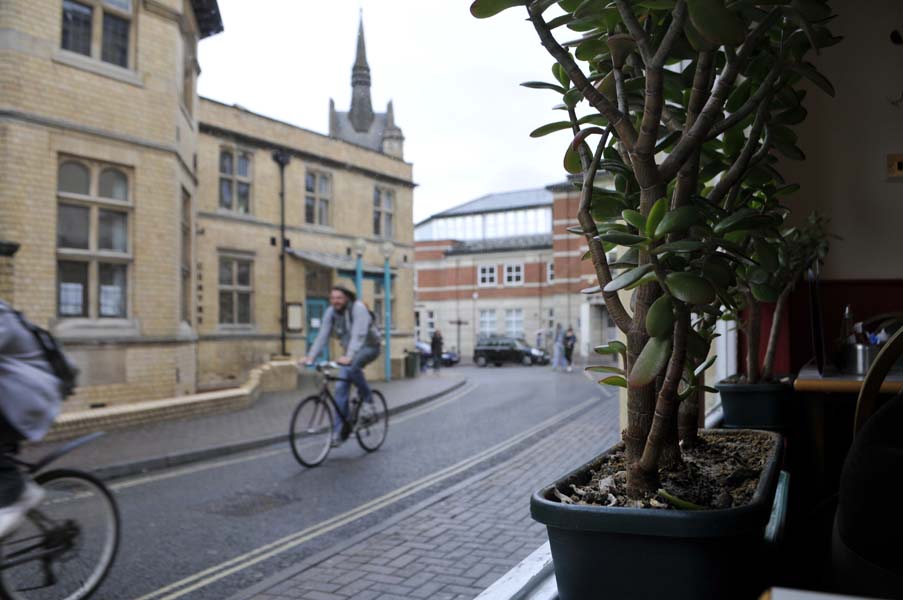 Cyclists from a cafe window .