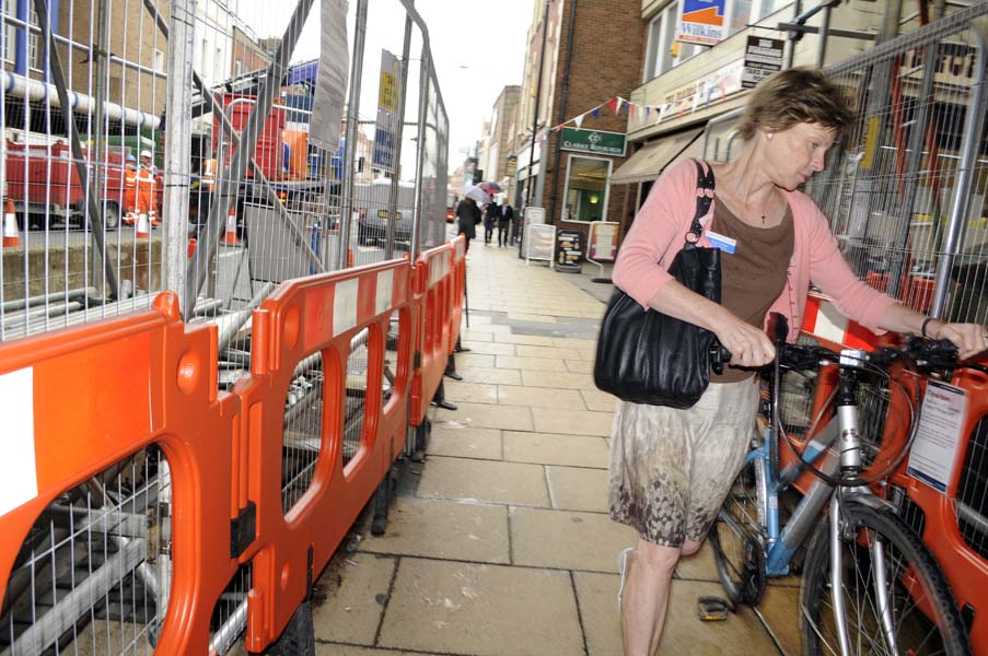 Lady with a push bike.