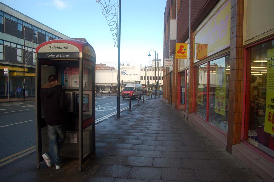 Man in a phone box.