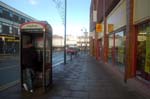 Man in a phone box.